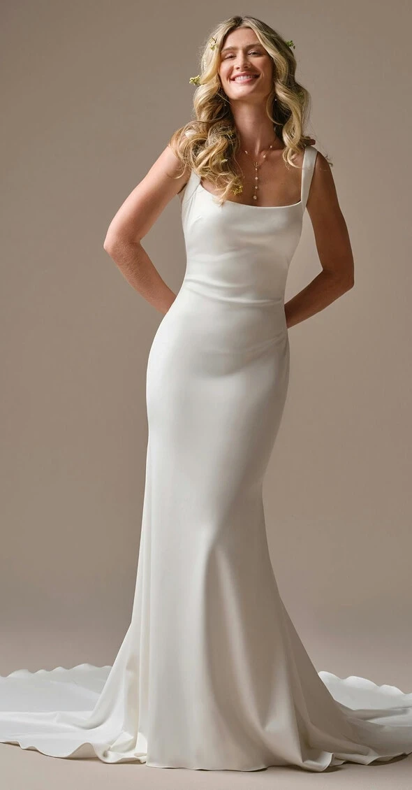 Model wearing a white gown by Rebecca Ingram